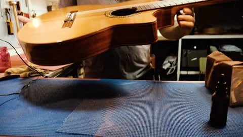 A luthier showing a guitar Stock Footage 160969059