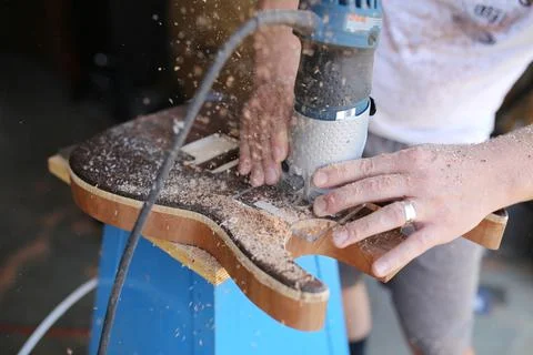 Luthier Using Power Tool to Build Handmade Wooden Electric Guitar Stock Photos