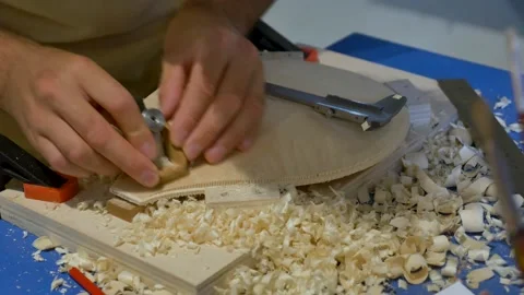 Luthier work on the sounding board of a stringed instrument. Vídeo Stock 141733214
