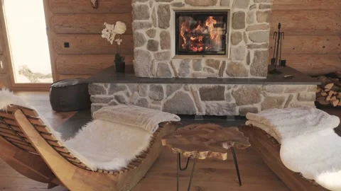 Luxurious and cozy rustic log cabin interior with a modern stone fireplace and Stock-Footage 335199068