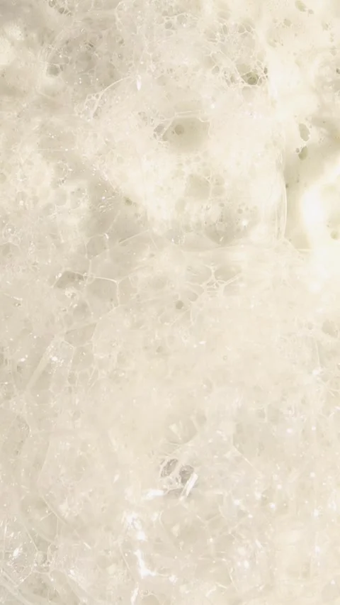 Luxurious ASMR soap foam bubbles dissolving in close-up view Stock Footage 309853932