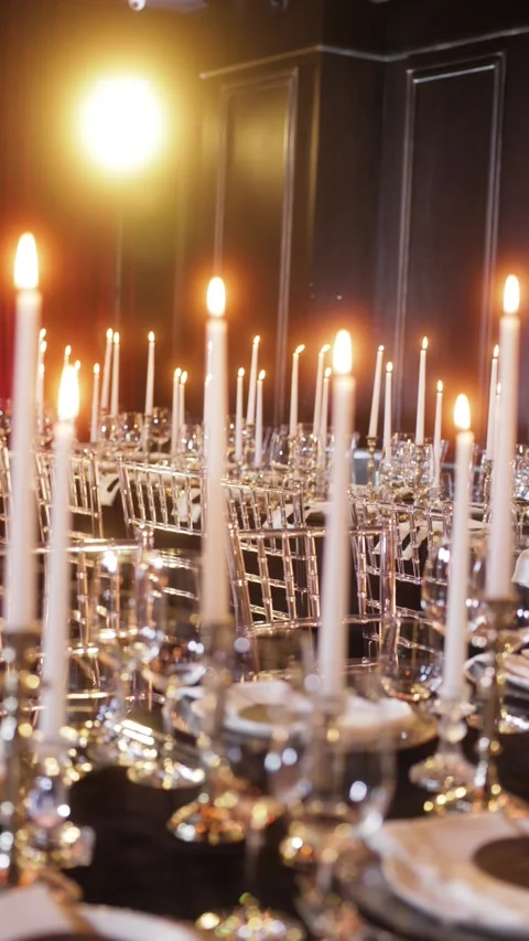 A luxurious banquet table elegantly set with white candles in silver Stock Footage 305677251