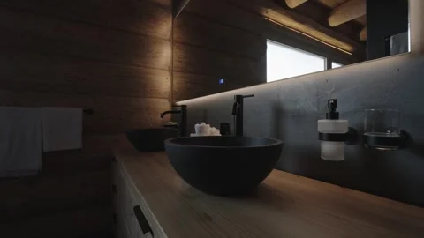 Luxurious bathroom featuring black sinks, wooden vanity, and a large mirror with Stock Footage 335756860