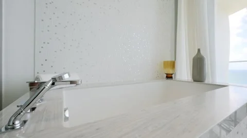 Luxurious bathtub design complemented by elegant mosaic tiles, marble finish and Stock-Footage 242942017