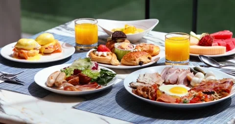 Luxurious breakfast spread with eggs, bacon, fresh pastries, fruit, Stock Footage 318119985