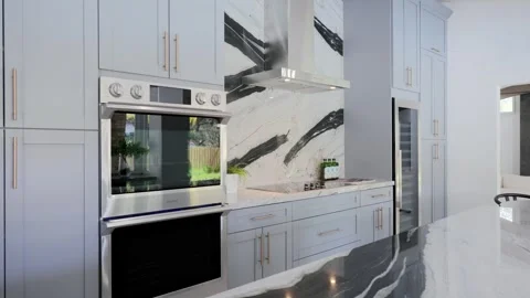 Luxurious bright matte kitchen with white cabinetry and built-in modern Stock Footage 249603261