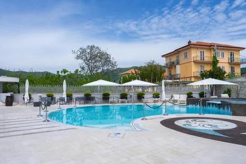 Luxurious Circular Pool with Mosaic Deck and Yellow Villa in Amalfi Stock Photos
