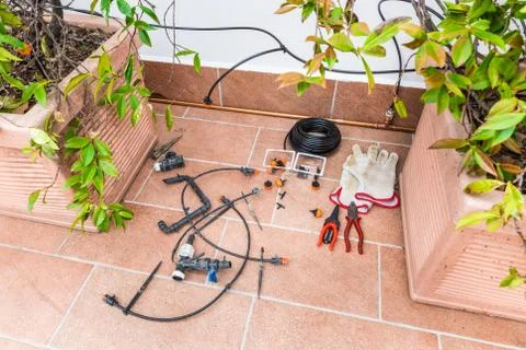 Luxurious copper drip irrigation system,  for pot plants on a terrace of a house Stock Photos