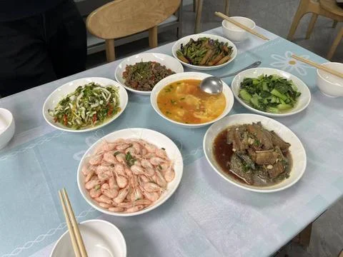Luxurious dinner table spread with multiple dishes Stock Photos