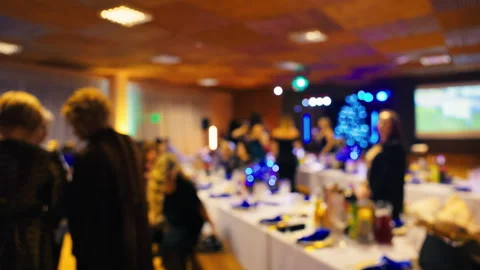 Luxurious event space hosting guests relaxing around tables with graceful Stock Footage 325009420