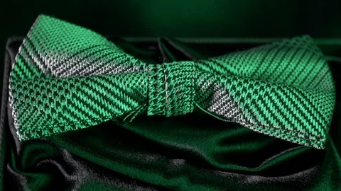Luxurious geometric pattern silk bow tie on black-  emerald light 4k Video stock 98405857