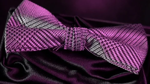 Luxurious geometric pattern silk bow tie on black -rich purple light 4k Stockbeeldmateriaal 98406313