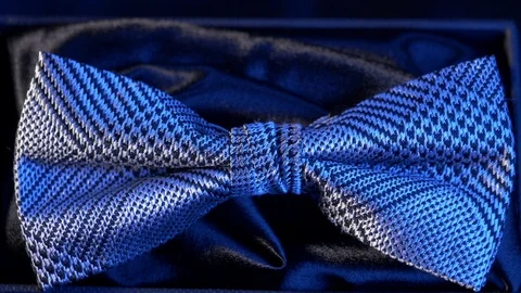Luxurious geometric pattern silk bow tie on black - sapphire light 4k Stock Footage 98406449