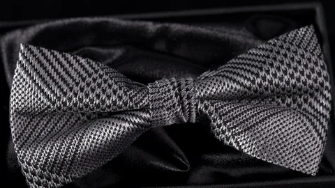 Luxurious geometric pattern silk bow tie on black 4k Stock Footage 98406777