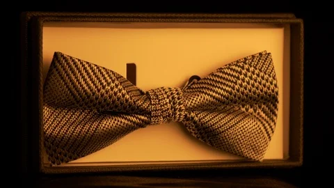 Luxurious geometric pattern silk in retail box - golden light 4k Stock Footage 98404116