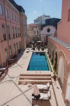 Luxurious Hotel Courtyard with Rectangular Pool and Elegant Architecture Stock Photos