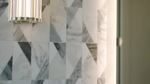 Luxurious interior of bathroom featuring marble wall with striking geometric Stock Footage 273867015