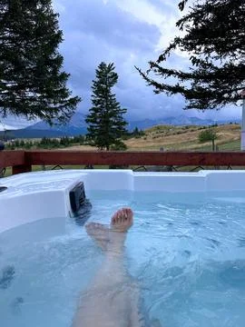Luxurious Jacuzzi on the background of mountain meadows and cliffs Stock Photos