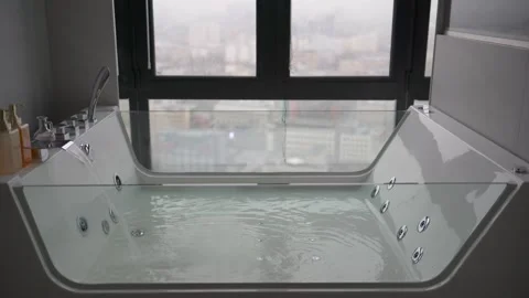 The luxurious Jacuzzi bath, with panoramic city views, is filled with water. Stock Footage 322998923