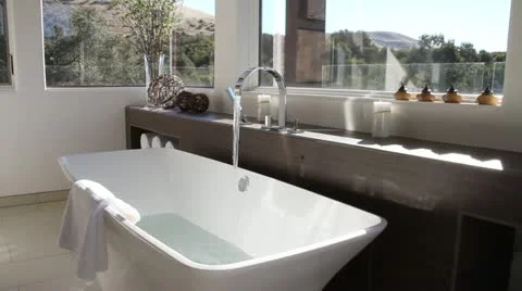 Luxurious modern bathroom with bathtub filling Stock Footage