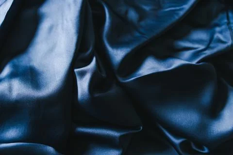 Luxurious navy blue silk or satin fabric close-up for bedding or clothes Stock Photos