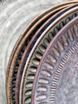 Luxurious patterned ceramic plates on shelves in supermarket, close up of b.. Stock Photos