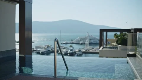 Luxurious rooftop infinity pool and marina with mega yacht on the Adriatic Stock Footage 329412184