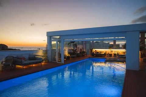 Luxurious Rooftop Pool at Sunset with Ocean View and Moroccan Style Stock Photos
