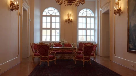 A luxurious room featuring elegant antique furniture with red upholstery, golden Stock Footage 294771190