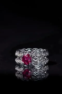 Luxurious ruby and diamond ring isolated on a black background 库存照片