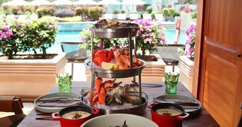 Luxurious seafood platter by poolside, featuring oysters, shrimp, Stock Footage 315578579