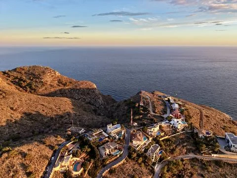 Luxurious seaside settlement perched on cliffs with expansive sea horizon and Stock Photos