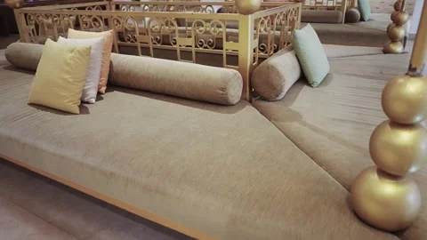 Luxurious seated arab style lounge featuring plush soft cushions in various p Stock Footage 336077481