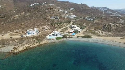 Luxurious villas with pools, surrounded by dry land with stones and arid bushes Stock Footage 87045163