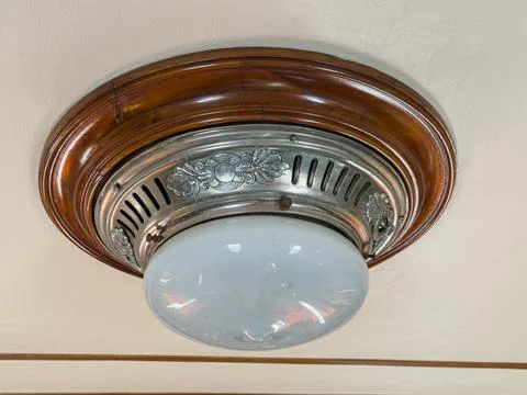 Luxurious vintage train interior, ceiling light fixture, circular wooden fr.. Stock Photos