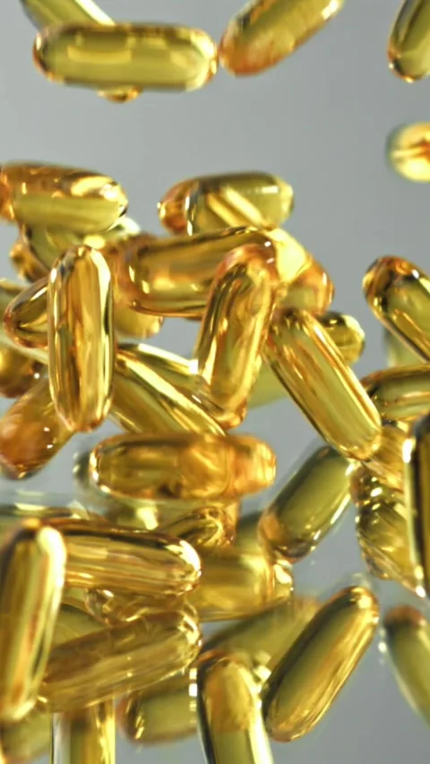 Luxurious vitamin capsules reflecting light Filmed on a high-speed camera at Stock Footage 335396027