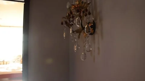 Luxurious wall lamp on the background of the open door to the bedroom Stock Footage 141288971