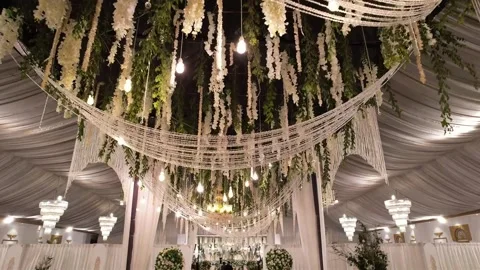 Luxurious Wedding Hall Ceiling with Grand Chandelier and Floral Decor Stock Footage 345270278