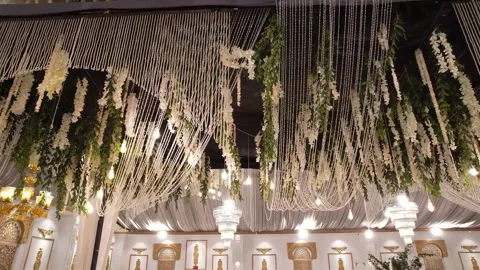 Luxurious Wedding Hall Ceiling with Grand Chandelier and Floral Decor Stock Footage 345270801