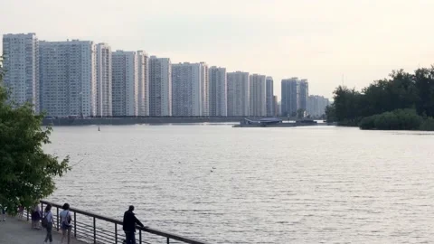 Luxury apartments on the river bank. People relax on the embankment Stock Footage