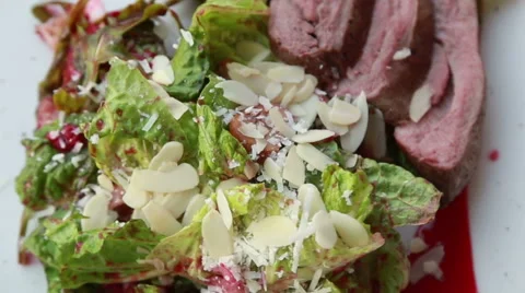 Luxury appetizing meat and fresh salad dish with almonds and bright berry sauce Stock Footage 61184178