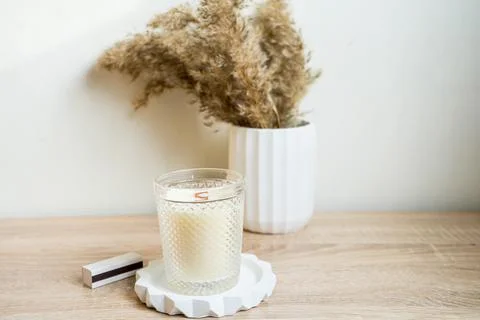 Luxury aroma lighting aromatic scented candle glass displayed on woden table Stock Photos