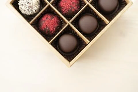 Luxury assorted chocolates in gift box. Handmade candy in an open box on white Stock Photos