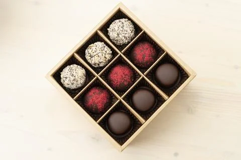 Luxury assorted chocolates in gift box. Handmade candy in an open box on white Stock Photos