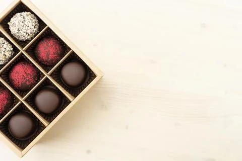 Luxury assorted chocolates in gift box. Handmade candy in an open box on white Stock Photos