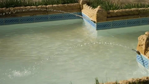 Luxury backyard swimming pool with elegant water deck jets Stock Footage 327330249