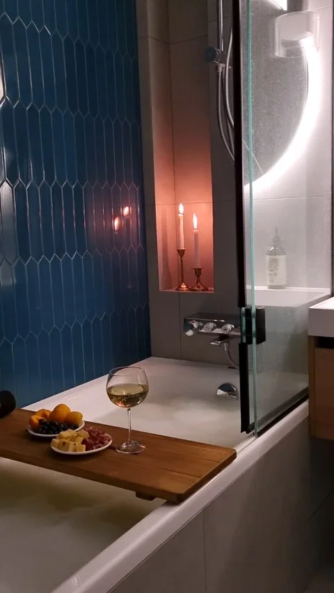 Luxury bathroom interior with hot bath, glass of wine and candles. Stock Footage 339911567