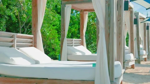 Luxury Beach Cabanas with White Daybeds and Privacy Curtains Stock Footage 346503928