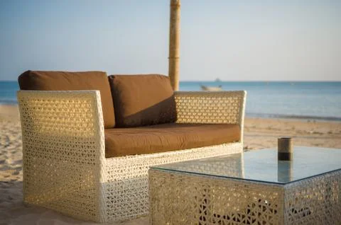 Luxury beach sofa and table on tropical island beach Stock Photos
