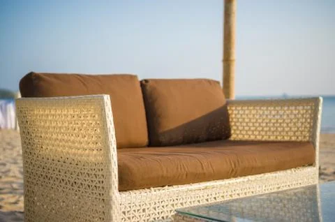 Luxury beach sofa and table on tropical island beach Stock Photos